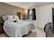 Spacious bedroom featuring soft carpet, a queen size bed, and a large window at 8144 Washington St # 192, Denver, CO 80229