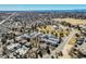 Aerial view of homes, lawns, mature trees, and a park in the distance at 15157 E Louisiana Dr # A, Aurora, CO 80012