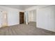 Bedroom with mirrored closet doors, a bathroom, and neutral carpeting at 15157 E Louisiana Dr # A, Aurora, CO 80012