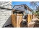 View of the exterior of the house showing a fenced in yard with wood slats for privacy at 15157 E Louisiana Dr # A, Aurora, CO 80012