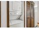 Hallway with stackable washer and dryer and a louvered closet door at 15157 E Louisiana Dr # A, Aurora, CO 80012