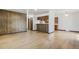 A spacious living room features laminate floors and vintage wood paneling with view to the kitchen at 15157 E Louisiana Dr # A, Aurora, CO 80012