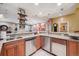 Finished basement features a wet bar with granite countertops, stylish lighting, and modern appliances at 5335 E 2Nd Ave, Denver, CO 80220