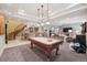 Finished basement featuring a pool table, wet bar, and cozy seating area with a fireplace at 5335 E 2Nd Ave, Denver, CO 80220