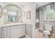 Charming bathroom features beautiful tile work, custom vanity, and a shower with elegant blue and white striped curtains at 5335 E 2Nd Ave, Denver, CO 80220