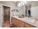 Bright bathroom with double sinks, a large mirror, walk in shower and stylish fixtures at 5335 E 2Nd Ave, Denver, CO 80220
