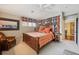 Spacious bedroom with a large bed, decorative pillows and curtains, and a cozy sitting area at 5335 E 2Nd Ave, Denver, CO 80220