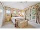 Bright bedroom with floral curtains and linens, plenty of natural light, and an ornate metal bed frame at 5335 E 2Nd Ave, Denver, CO 80220