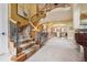 Open floor plan features a sweeping staircase, piano and open view to the dining room at 5335 E 2Nd Ave, Denver, CO 80220