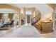 Entryway with grand staircase, chandelier and view into the living area at 5335 E 2Nd Ave, Denver, CO 80220