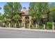 Stunning home exterior with manicured landscaping, mature trees, and a clay tile roof at 5335 E 2Nd Ave, Denver, CO 80220