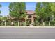 Inviting two-story home with beautiful landscaping, mature trees, and a clay tile roof at 5335 E 2Nd Ave, Denver, CO 80220