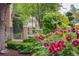 Landscaped front yard featuring a fountain, flowers, and manicured greenery enhancing curb appeal at 5335 E 2Nd Ave, Denver, CO 80220