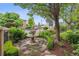 Beautifully landscaped front yard with a decorative fountain and lush greenery at 5335 E 2Nd Ave, Denver, CO 80220