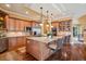 Well-equipped kitchen with wooden cabinets, granite countertops, and island with bar seating adjacent to the living area at 5335 E 2Nd Ave, Denver, CO 80220