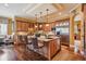 Open-concept kitchen boasting wooden cabinets, granite countertops, an island with bar seating, and stainless steel appliances at 5335 E 2Nd Ave, Denver, CO 80220