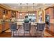 Beautiful kitchen featuring wooden cabinets, granite countertops, stainless steel appliances, and an island with bar seating at 5335 E 2Nd Ave, Denver, CO 80220