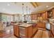 Spacious kitchen with wood cabinets, granite countertops, island seating, and modern appliances, perfect for entertaining at 5335 E 2Nd Ave, Denver, CO 80220