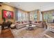 Bright living room with large sectional, colorful pillows, and large windows offering natural light at 5335 E 2Nd Ave, Denver, CO 80220
