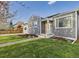 A cozy home featuring gray siding, white trim and neat landscaping at 940 Hooker St, Denver, CO 80204