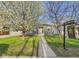 Charming gray home with a well-manicured lawn and blossoming tree at 940 Hooker St, Denver, CO 80204