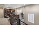 Spacious home office featuring custom wood shelving and a modern railing at 21284 E 63Rd Dr, Aurora, CO 80019