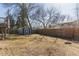 Large grassy backyard with a wooden fence and storage shed at 2161 Bowen St, Longmont, CO 80501