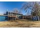 Spacious backyard with a deck, pergola, storage shed, and mature tree at 2161 Bowen St, Longmont, CO 80501