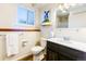 Bright bathroom featuring a new vanity, updated fixtures, and a window providing natural light at 2161 Bowen St, Longmont, CO 80501