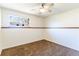 Simple bedroom with white walls, carpeted floors, and a bright window at 2161 Bowen St, Longmont, CO 80501