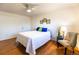 Simple bedroom with white walls, wood floors, and a full size bed with bright decorative pillows at 2161 Bowen St, Longmont, CO 80501