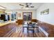 Bright dining area features wood paneling, hardwood floors, a glass table, and sliding door access to the deck at 2161 Bowen St, Longmont, CO 80501