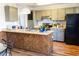 Well-lit kitchen with wood counter tops, black appliances, and ample storage at 2161 Bowen St, Longmont, CO 80501