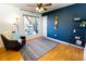 Cozy living room features hardwood floors, a bright window, comfortable seating, and a dark accent wall at 2161 Bowen St, Longmont, CO 80501