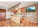 Basement tiki bar has unique design, bamboo construction, shelves and mounted television at 4534 Palmer Ct, Longmont, CO 80503