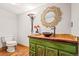Bathroom features a wooden vanity, vessel sink, decorative mirror, and flooring at 4534 Palmer Ct, Longmont, CO 80503