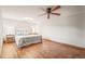Bedroom with hardwood floors, ceiling fan, and accent tables at 4534 Palmer Ct, Longmont, CO 80503
