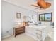 Inviting bedroom featuring a ceiling fan, window seat, and ample natural light at 4534 Palmer Ct, Longmont, CO 80503