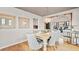 Charming dining room featuring hardwood floors, an elegant light fixture, and a view of the living room at 4534 Palmer Ct, Longmont, CO 80503