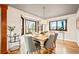 Bright dining room featuring hardwood floors, large windows, and elegant table setting at 4534 Palmer Ct, Longmont, CO 80503