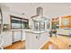 Bright, open kitchen featuring a gas stovetop island, stainless steel appliances, and scenic views from the large window at 4534 Palmer Ct, Longmont, CO 80503