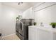 Functional laundry room featuring modern washer and dryer, ample cabinet space, and a utility sink for added convenience at 4534 Palmer Ct, Longmont, CO 80503