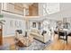 Spacious living area with open layout, seamlessly connecting to the dining area and kitchen, under a soaring ceiling at 4534 Palmer Ct, Longmont, CO 80503