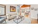 Cozy living room with hardwood floors, a stylish sofa, and an open view of the dining area at 4534 Palmer Ct, Longmont, CO 80503