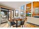 Inviting living room with floor-to-ceiling fireplace, entertainment center and beautiful outdoor views from multiple large windows at 4534 Palmer Ct, Longmont, CO 80503