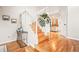 Lovely home staircase featuring hardwood steps and white railings, complemented by stylish decor at 4534 Palmer Ct, Longmont, CO 80503