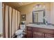 Bathroom with large shower, granite countertops, dark wood cabinets, and modern fixtures at 9406 Troon Village Way, Lone Tree, CO 80124