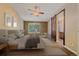 Nicely decorated bedroom featuring a ceiling fan, and sliding barn door to the ensuite at 9406 Troon Village Way, Lone Tree, CO 80124