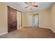Spacious bedroom with a barn door leading to ensuite bathroom and other rooms at 9406 Troon Village Way, Lone Tree, CO 80124