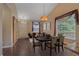 Elegant dining room featuring a chandelier, hardwood floors, and large windows at 9406 Troon Village Way, Lone Tree, CO 80124